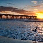 sunrise with pier at beach